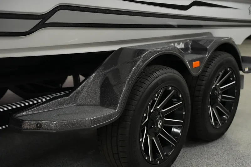Slide: The Image of 2026 Bass Cat Puma STS trailer with dual black alloy wheels and sleek design. - 11