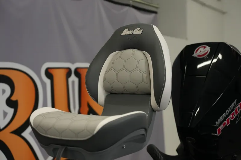 Slide: The Image of 2026 Bass Cat Puma STS boat seat with hexagonal pattern, next to Mercury Pro engine. - 13
