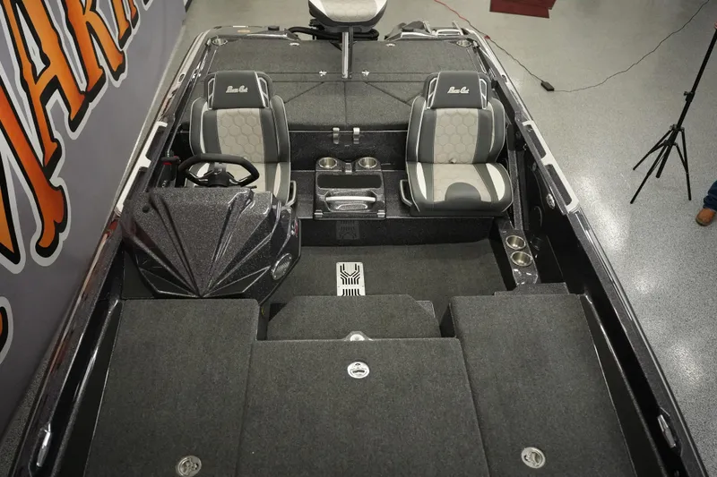 Slide: The Image of 2026 Bass Cat Puma STS boat interior with dual seats and steering console. - 16