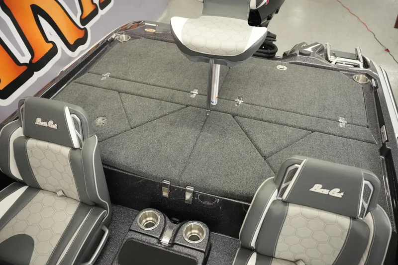 Slide: The Image of 2026 Bass Cat Puma STS boat interior with gray seating and carpeted deck. - 25