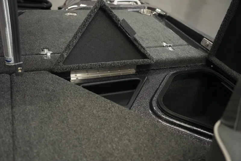 Slide: The Image of 2026 Bass Cat Puma STS boat interior storage compartments with carpeted lids and secure latches. - 28