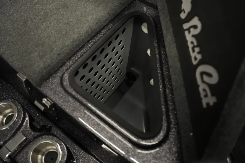 Slide: The Image of 2026 Bass Cat Puma STS interior storage compartment with cup holders and logo detail. - 29