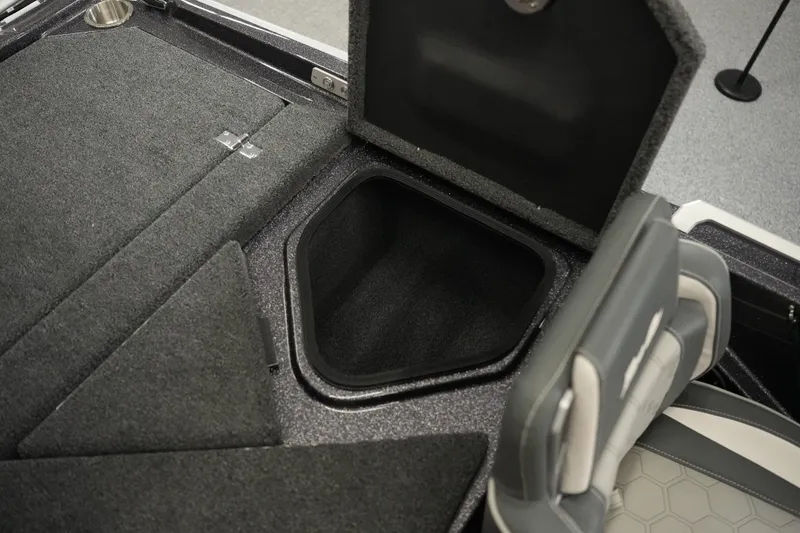 Slide: The Image of 2026 Bass Cat Puma STS boat interior storage compartment with open lid and seating. - 31