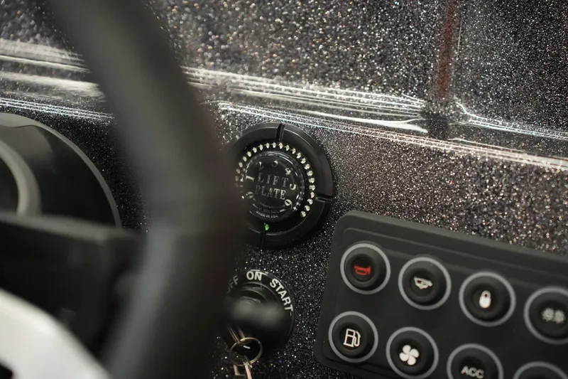 Slide: The Image of 2026 Bass Cat Puma STS dashboard with lift plate control and ignition key. - 38