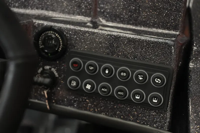 Slide: The Image of Dashboard controls of 2026 Bass Cat Puma STS boat with various buttons and dials. - 39