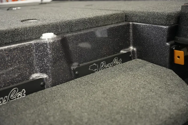 Slide: The Image of 2026 Bass Cat Puma STS boat interior with textured flooring and branding details. - 42