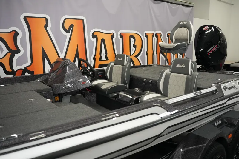 Slide: The Image of 2026 Bass Cat Puma STS boat with sleek design and comfortable seating in showroom. - 5