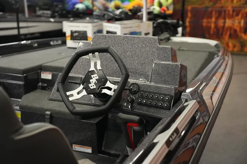 Slide: The Image of 2026 Bass Cat Puma STS boat dashboard with steering wheel and control panel. - 7