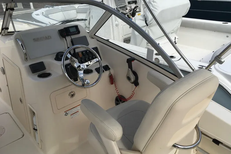 Slide: The Image of 2021 Grady-White Freedom 215 boat cockpit with steering wheel and controls. - 10