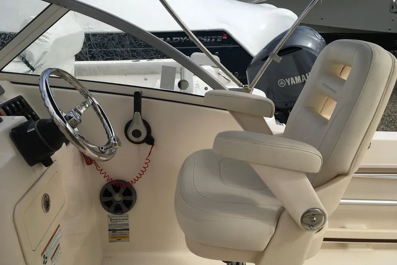 Slide: The Image of 2021 Grady-White Freedom 215 boat interior with steering wheel and captain's chair. - 8