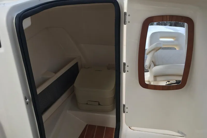 Slide: The Image of 2021 Grady-White Freedom 215 boat interior with mirror and storage compartment. - 9