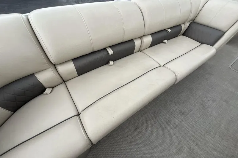 Slide: The Image of 2021 Sun Tracker Party Barge 22 XP3 interior seating, featuring plush, beige upholstery. - 10