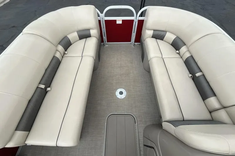 Slide: The Image of 2021 Sun Tracker Party Barge 22 XP3 interior with beige seating and red accents. - 11