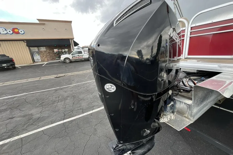 Slide: The Image of 2021 Sun Tracker Party Barge 22 XP3 with Mercury outboard motor in parking lot. - 19