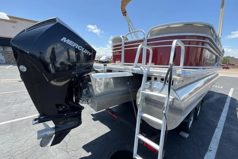 Slide: The Image of 2021 Sun Tracker Party Barge 22 XP3 with Mercury outboard motor, parked outdoors. - 5