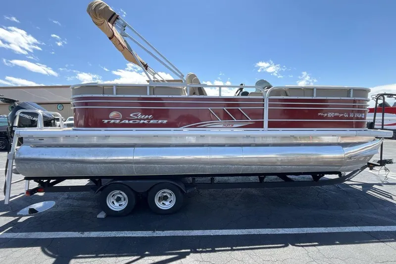 Slide: The Image of 2021 Sun Tracker Party Barge 22 XP3 pontoon boat on trailer, sunny day. - 6