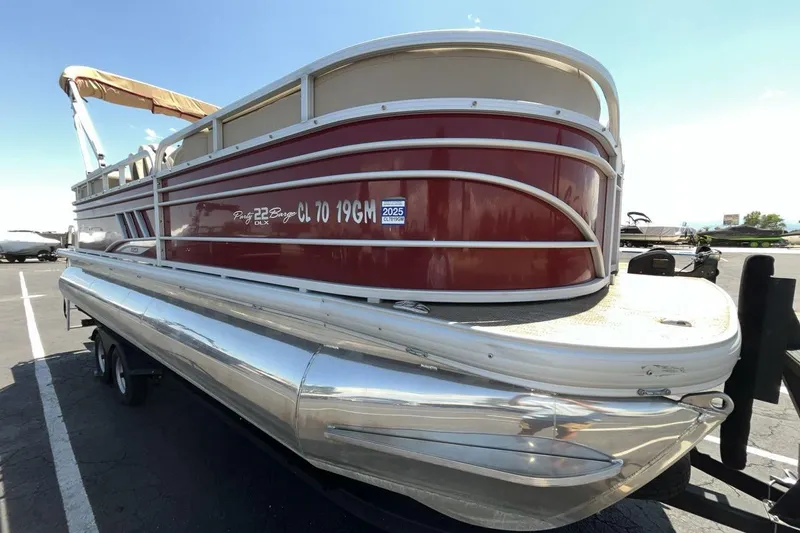 Slide: The Image of 2021 Sun Tracker Party Barge 22 XP3 pontoon boat in a parking lot. - 7