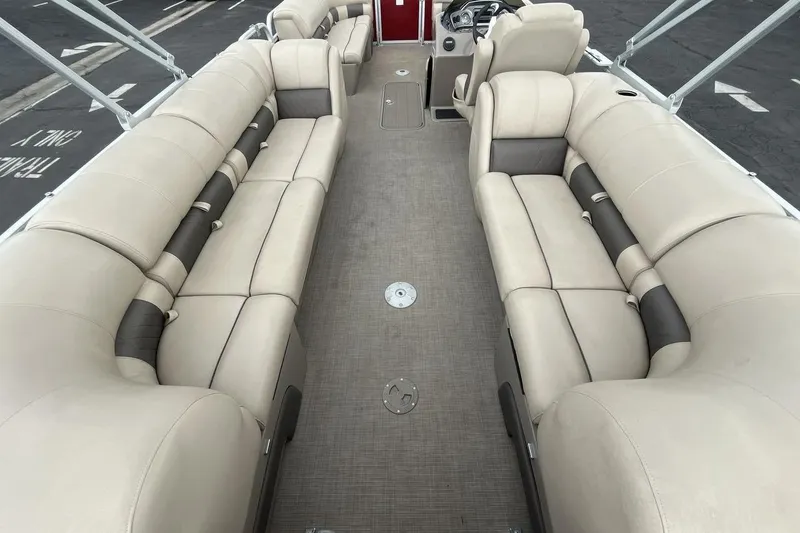 Slide: The Image of 2021 Sun Tracker Party Barge 22 XP3 interior with beige seating and spacious layout. - 9