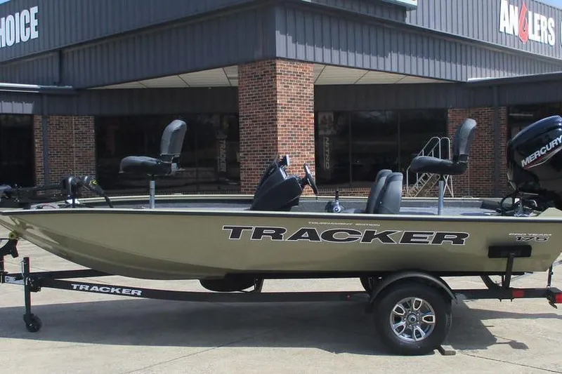 The Image of 2026 Tracker Pro Team 175 boat on trailer outside a store, featuring Mercury engine. - 1