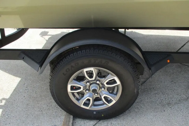 Slide: The Image of Trailer wheel of 2026 Tracker Pro Team 175 boat on concrete surface. - 10
