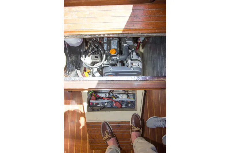 Slide: The Image of Engine compartment of a 1979 Islander Sloop with visible mechanical components. - 11