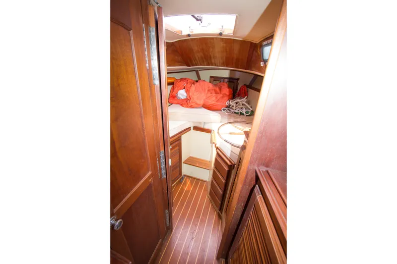 Slide: The Image of Interior of a 1979 Islander Sloop sailboat with wooden finishes and cozy cabin space. - 7