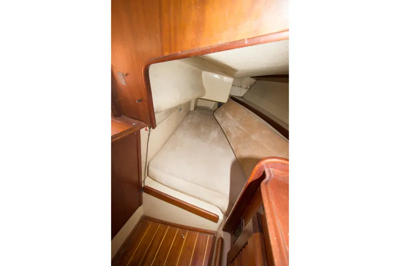 Slide: The Image of 1979 Islander Sloop cabin interior with wooden finish and cozy sleeping area. - 8