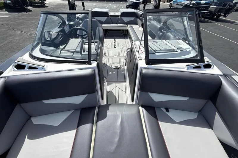 Slide: The Image of 2022 Moomba Makai boat interior with dual windshields and spacious seating. - 12