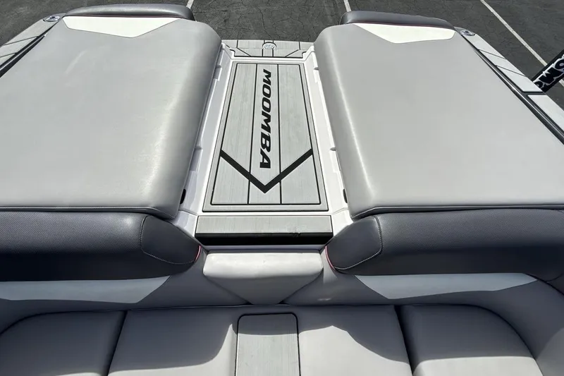 Slide: The Image of 2022 Moomba Makai boat interior with cushioned seating and branded flooring. - 19