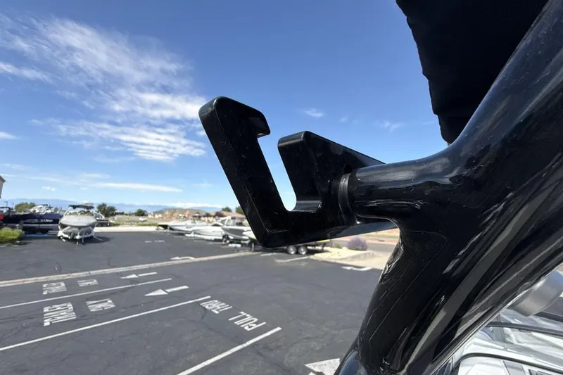 Slide: The Image of 2022 Moomba Makai boat detail with parking lot and boats in background. - 25