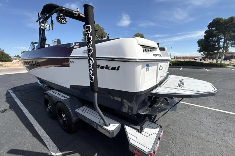 Slide: The Image of 2022 Moomba Makai boat on trailer in parking lot, rear view. - 3