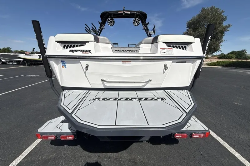 Slide: The Image of 2022 Moomba Makai boat rear view with swim platform and Raptor engine branding. - 4