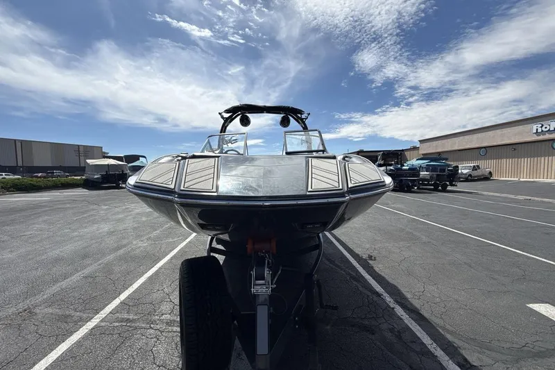 Slide: The Image of 2022 Moomba Makai boat parked in a lot under a clear blue sky. - 8