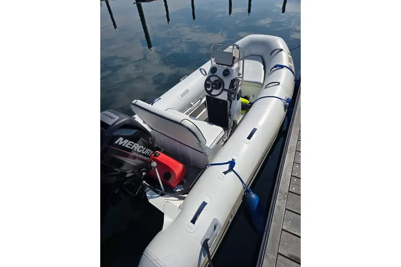 Slide: The Image of 2016 Quicksilver Center Console boat docked, featuring Mercury outboard motor. - 5