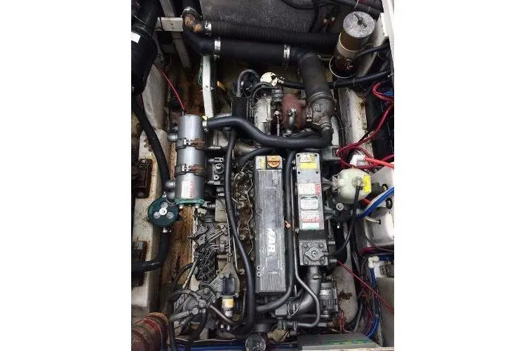 Slide: The Image of Engine compartment of a 2000 Stamas 310 Express boat, showcasing detailed mechanical components. - 11
