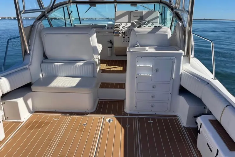 Slide: The Image of 2000 Stamas 310 Express boat interior with white seating and wooden deck. - 4