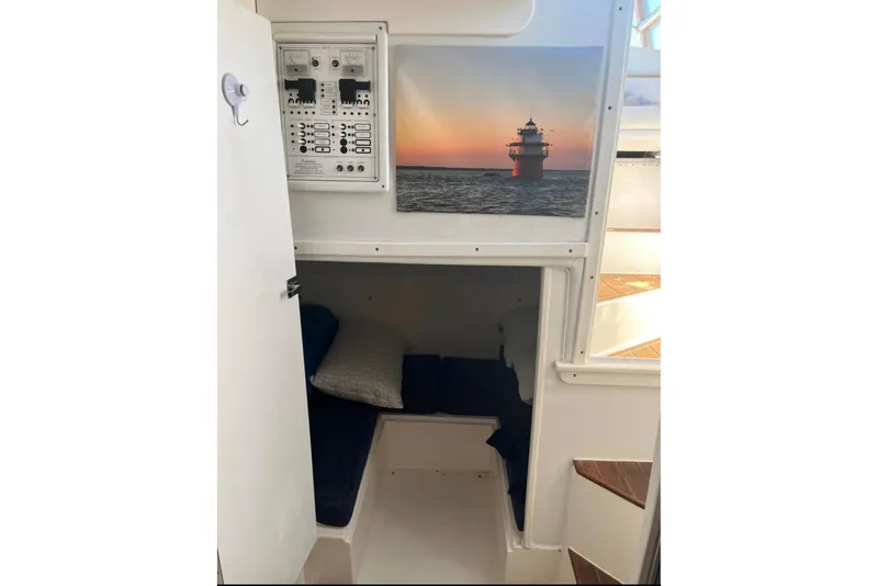 Slide: The Image of Interior cabin of 2000 Stamas 310 Express boat with cozy sleeping area and control panel. - 9