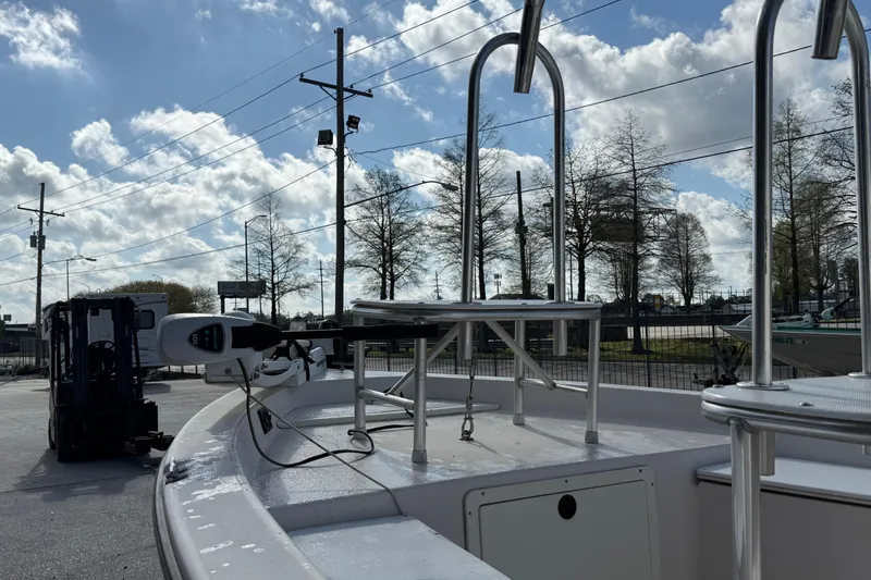 Slide: The Image of 2002 Pathfinder 1900 V boat with metal railings under a partly cloudy sky. - 12