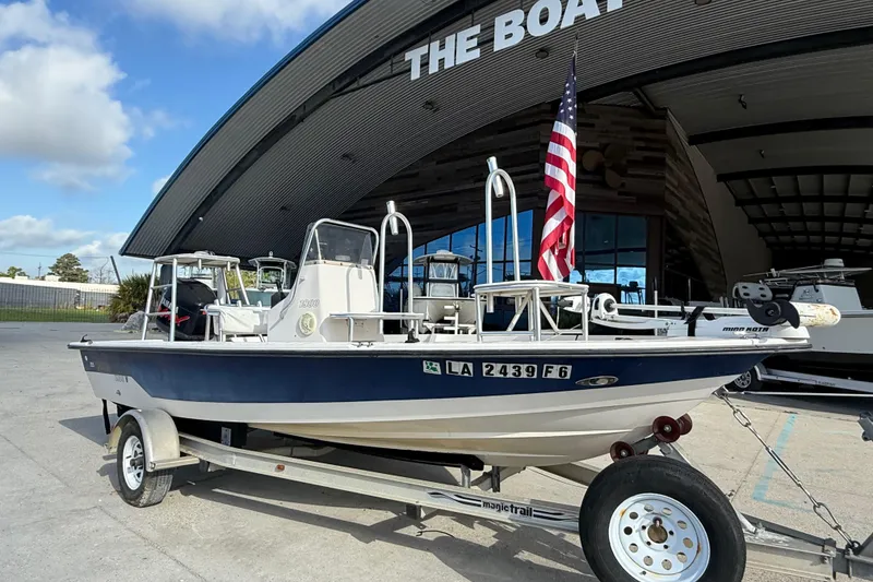 Slide: The Image of 2002 Pathfinder 1900 V boat on trailer, parked outside a boat dealership. - 2