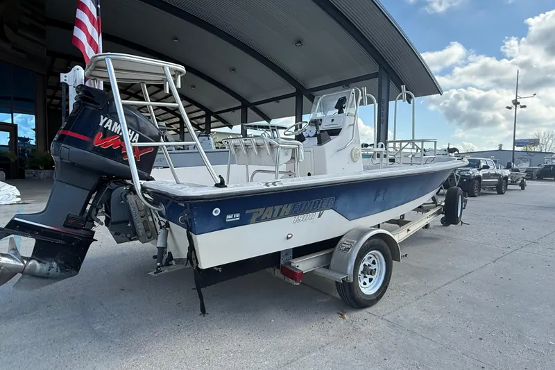 Slide: The Image of 2002 Pathfinder 1900 V boat with Yamaha engine on trailer, parked outdoors. - 3