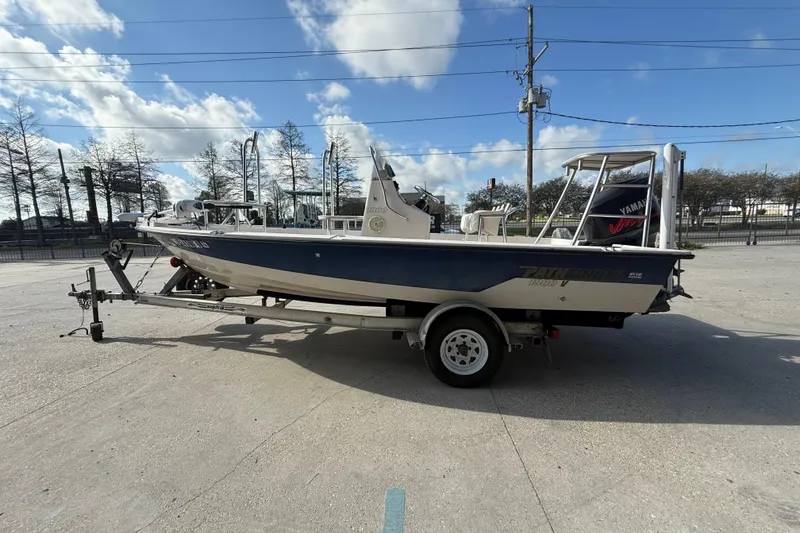 Slide: The Image of 2002 Pathfinder 1900 V boat on trailer under blue sky. - 8