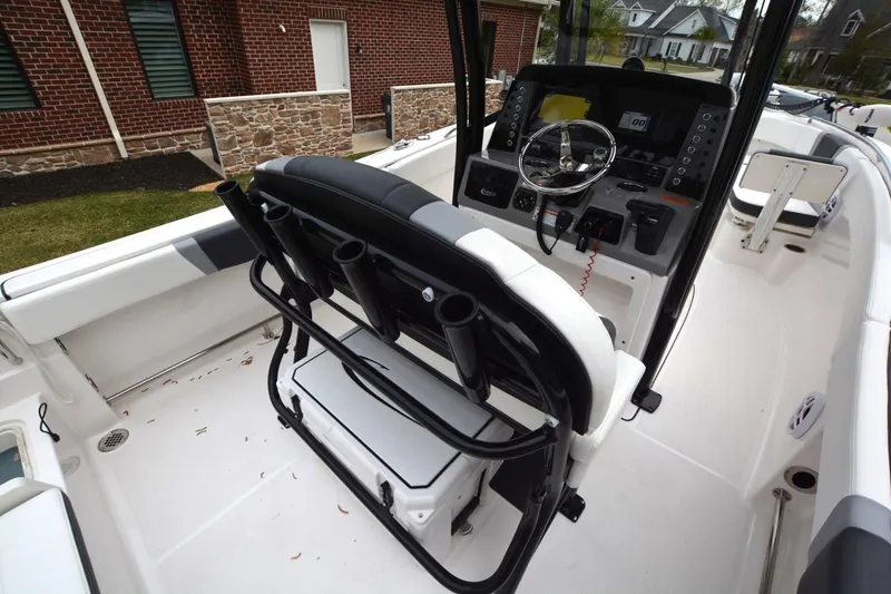 Slide: The Image of 2023 Robalo R230 Center Console boat interior with steering wheel and seating. - 11