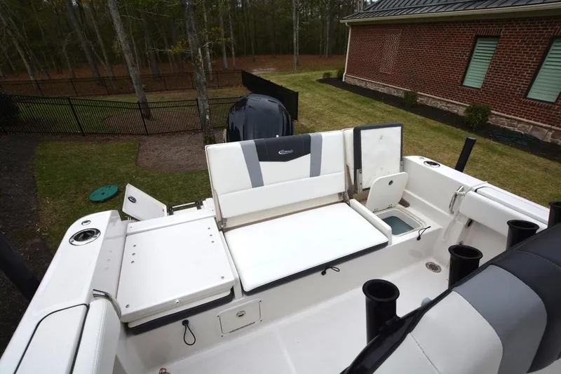 Slide: The Image of 2023 Robalo R230 Center Console boat interior with seating and storage features. - 12