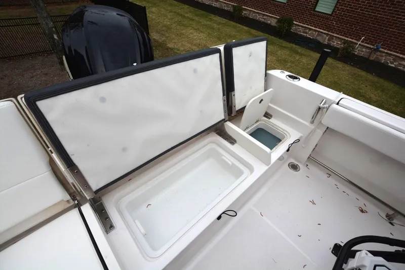 Slide: The Image of 2023 Robalo R230 Center Console boat with open storage compartments. - 13