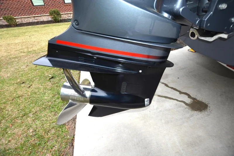 Slide: The Image of 2023 Robalo R230 Center Console boat engine with Yamaha propeller on concrete surface. - 17