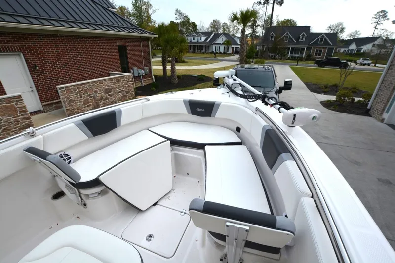 Slide: The Image of 2023 Robalo R230 Center Console boat parked in a residential driveway. - 5