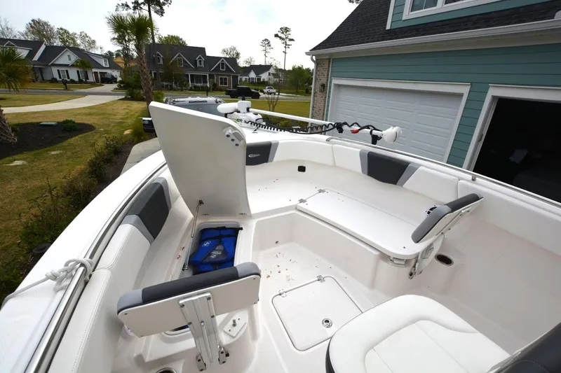 Slide: The Image of 2023 Robalo R230 Center Console boat interior with seating and storage compartments. - 7