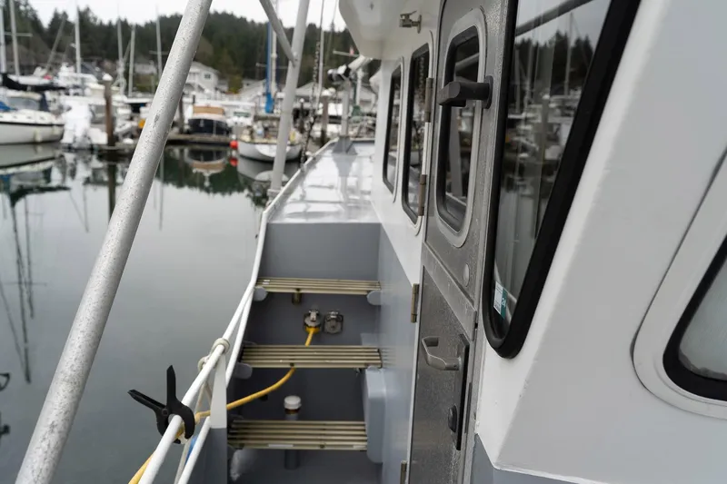 Slide: The Image of Side view of a 1997 Custom Steel Trawler docked in a marina. - 10