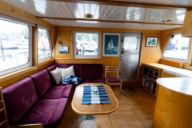 Slide: The Image of Interior of a 1997 Custom Steel Trawler with cozy seating and nautical decor. - 11