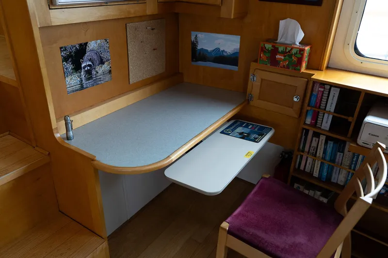 Slide: The Image of Cozy workspace on a 1997 Custom Steel Trawler with desk, chair, and bookshelves. - 15